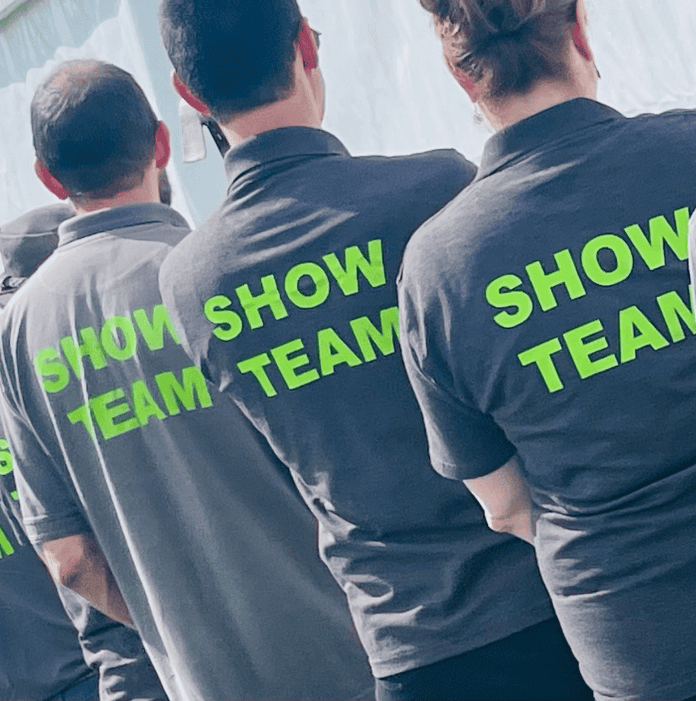 Volunteers Howden Show volunteers show the back of their tshirts, which read "Show Team"